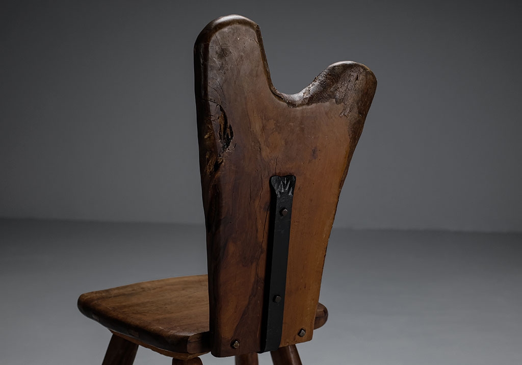 Tony Bain chair in olive wood and cast iron seen from the back. Detail of the cast iron piece.