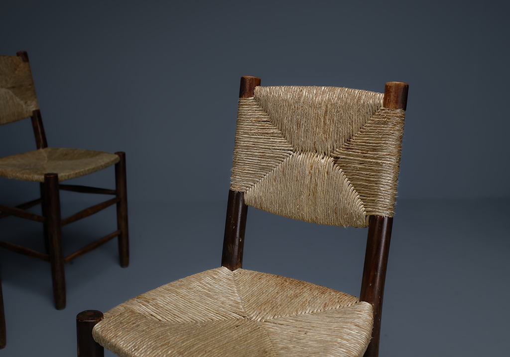 Set of 4 "Bauche" Chairs: detail of the straw backrest with the seat peeking from the bottom of the image