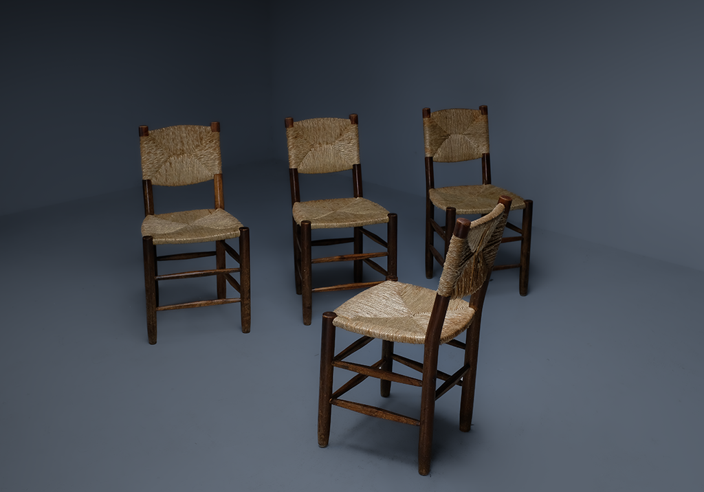 Set of 4 "Bauche" Chairs: diagonal chair facing a row of the three other chairs in a row 