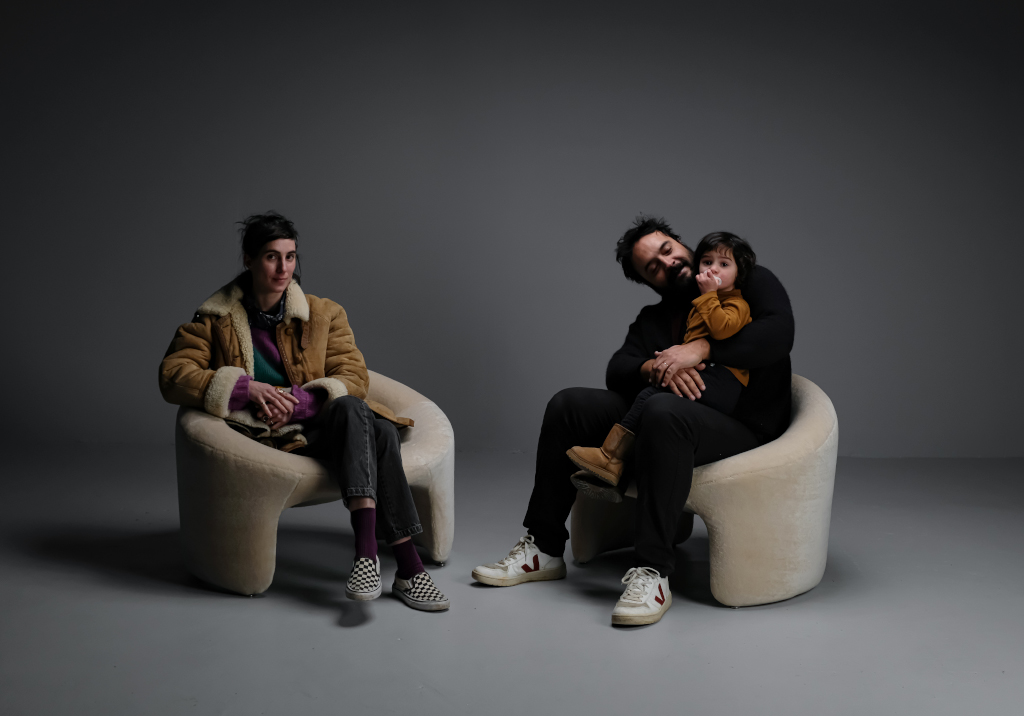 On the left, Justine is seating in a Olivier Mourgue Chair. On the right, César carry their daughter Suzanne in his arms